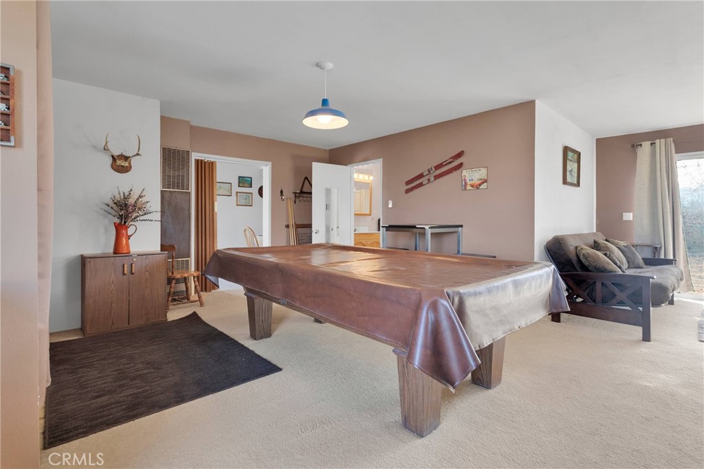 9482 Palomar Trail Lucerne Valley, CA 92356 - Photo 15 of 45 a spacious bedroom with a bed and glass table
