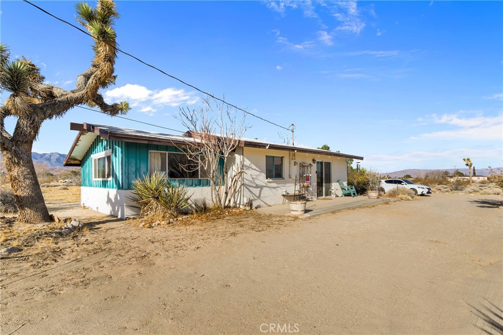 9482 Palomar Trail Lucerne Valley, CA 92356 - Photo 29 of 45 a view of a house with a snow in the yard
