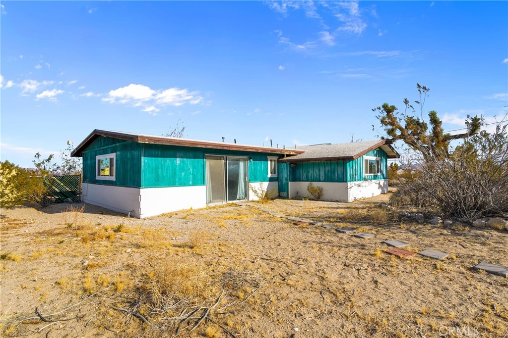 9482 Palomar Trail Lucerne Valley, CA 92356 - Photo 31 of 45 a front view of a house with a yard and garage