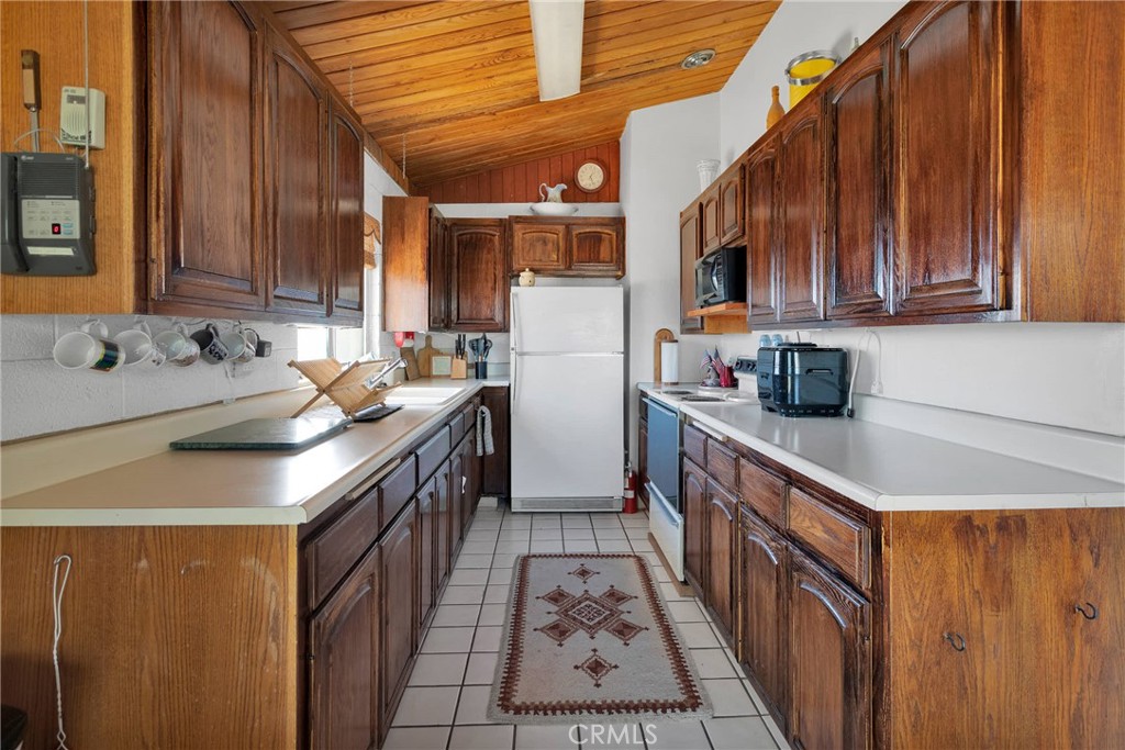 9482 Palomar Trail Lucerne Valley, CA 92356 - Photo 9 of 45 a kitchen with stainless steel appliances granite countertop a sink stove and cabinets