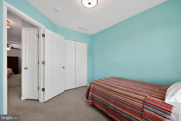 a bedroom with a bed and a fan