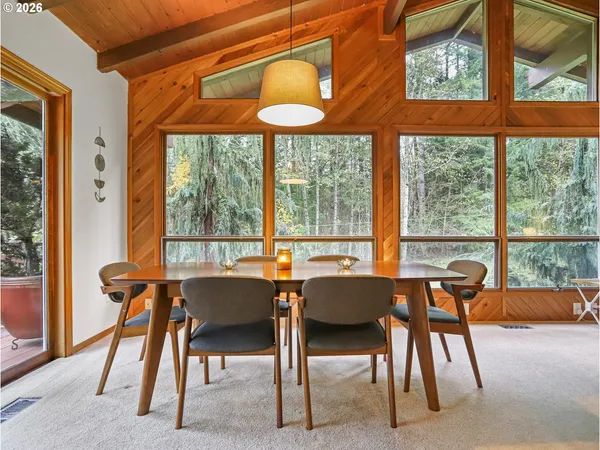 a dining room with furniture and a window