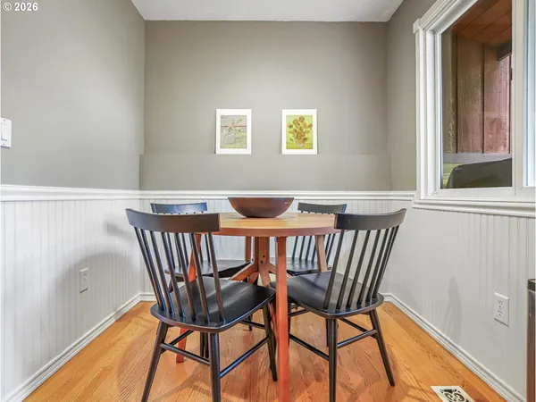 a view of a dining room with furniture and wooden floor