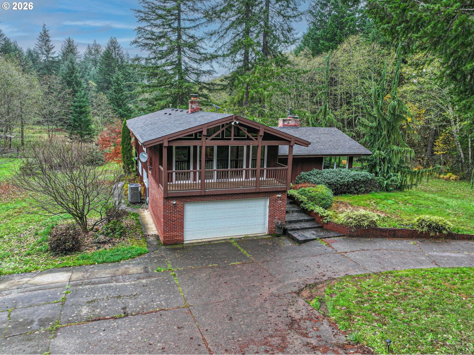 45990 Southeast Jadrny Road Sandy, OR 97055 - Photo 2 of 47 a front view of a house with a garden