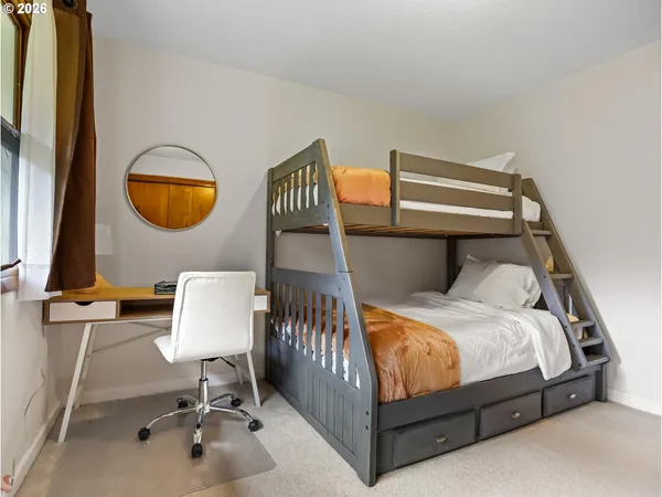 a bedroom with a bed and a mirror