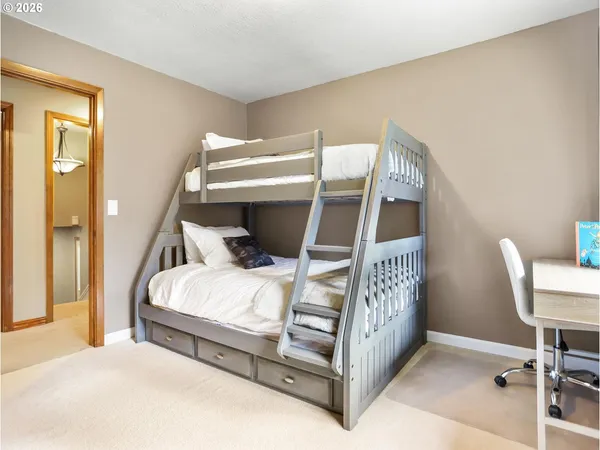 a bedroom with a bed and a chair