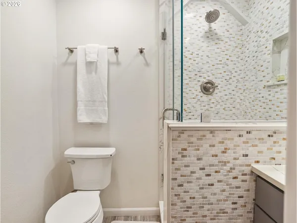 a bathroom with a toilet and a shower
