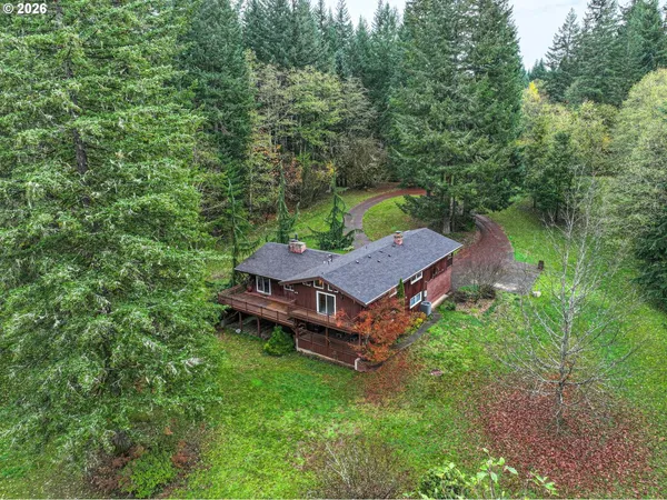 an aerial view of a house with a yard