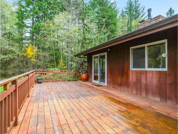a view of backyard with a deck and wooden floor