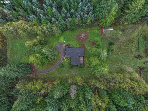 an aerial view of a house with a yard