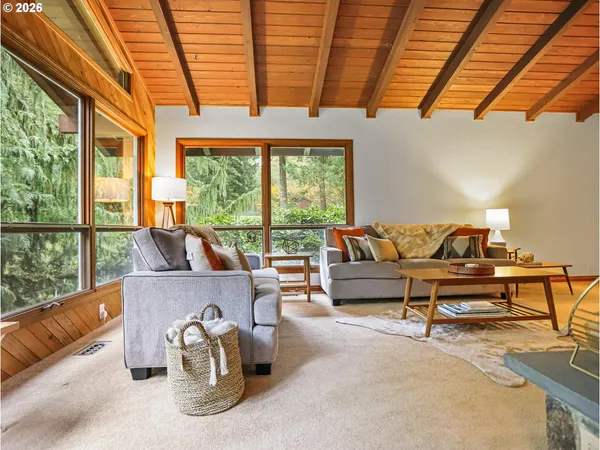 a living room with furniture and a floor to ceiling window