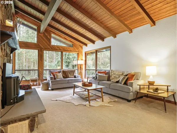 a living room with furniture and a floor to ceiling window