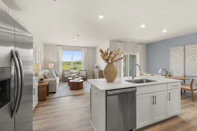 a kitchen with sink refrigerator and stove
