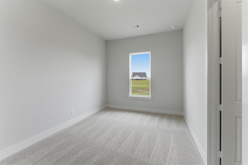 2204 Continent Court Krum, TX 76249 - Photo 22 of 28 Carpeted interior room with white walls, baseboards, and ceiling