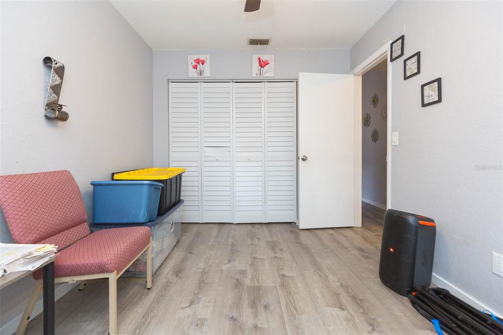 7703 Robert E Lee Road Tampa, FL 33637 - Photo 15 of 23 a view of room with furniture and wooden floor