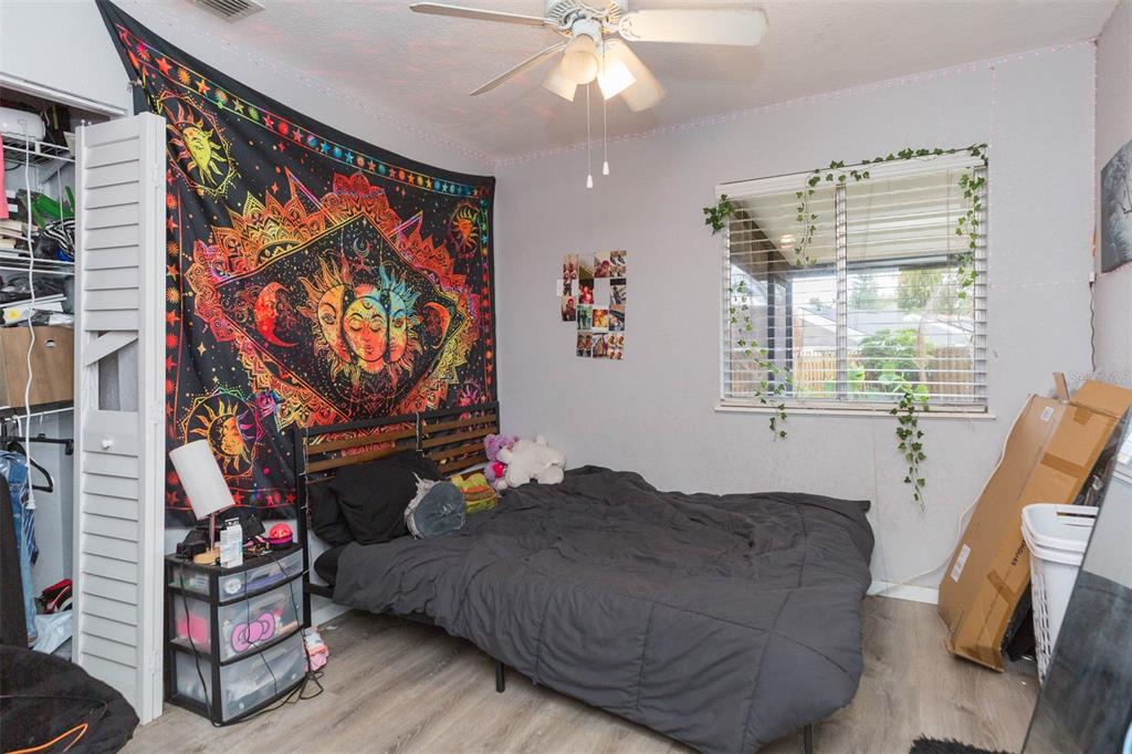 7703 Robert E Lee Road Tampa, FL 33637 - Photo 18 of 23 a bedroom with a bed and a painting on the wall