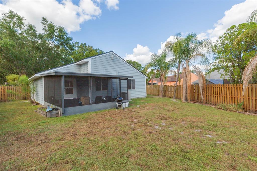 7703 Robert E Lee Road Tampa, FL 33637 - Photo 23 of 23 a view of a house with backyard and a tree