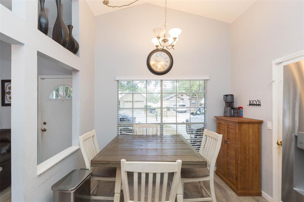 7703 Robert E Lee Road Tampa, FL 33637 - Photo 8 of 23 a view of a dining room with furniture window and wooden floor