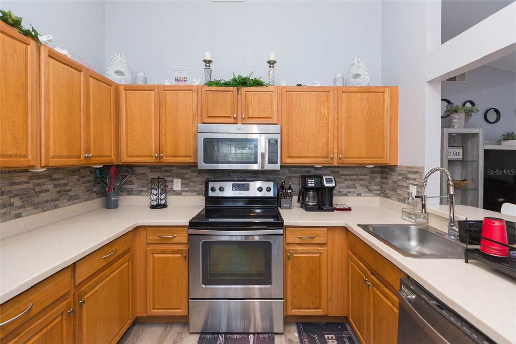 7703 Robert E Lee Road Tampa, FL 33637 - Photo 10 of 23 a kitchen with a sink a stove and cabinets