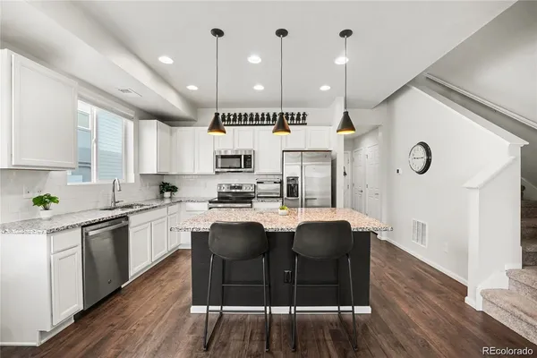 a large kitchen with lots of counter space dining table and chairs
