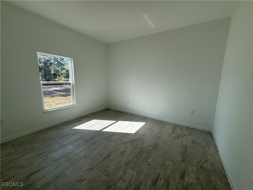 1853 Norma Court Lehigh Acres, FL 33972 - Photo 11 of 19 an empty room with a window