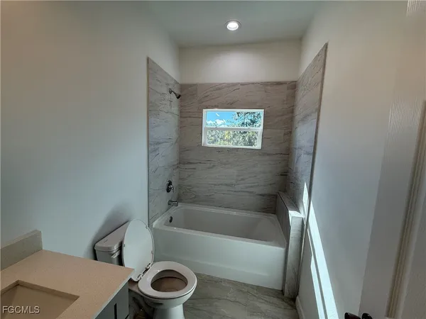a bathroom with a bathtub and a toilet