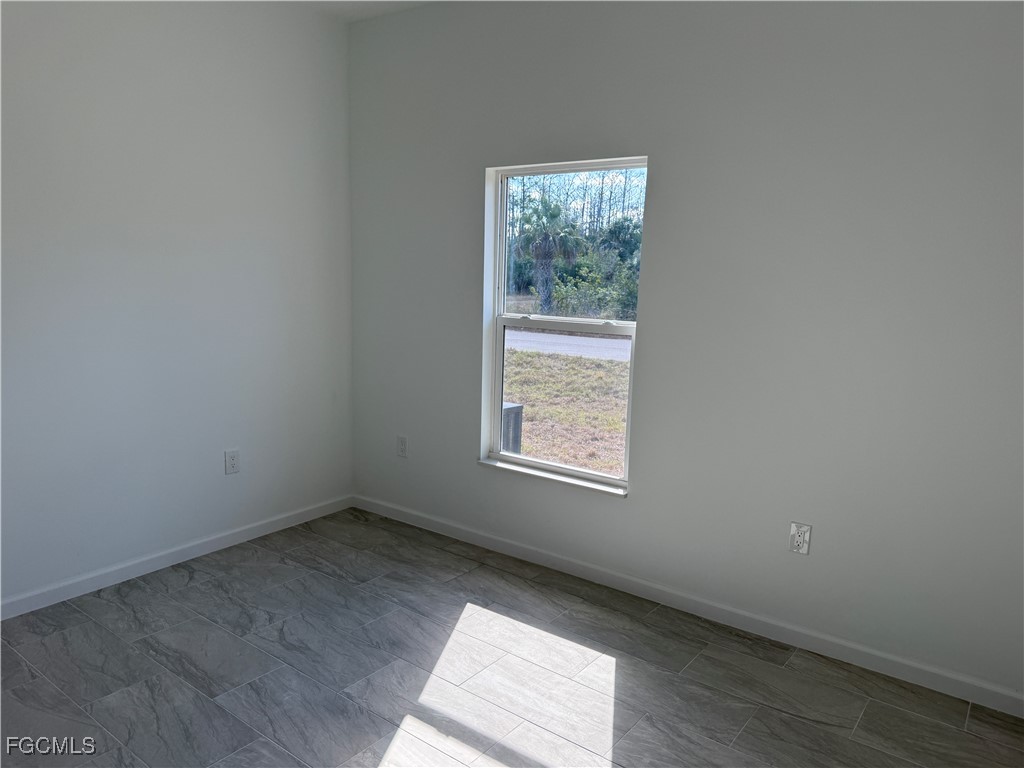 1853 Norma Court Lehigh Acres, FL 33972 - Photo 14 of 19 an empty room with a window