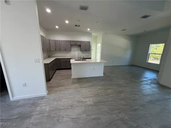 a view of kitchen with sink and microwave
