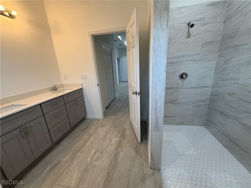 1853 Norma Court Lehigh Acres, FL 33972 - Photo 7 of 19 a bathroom with a sink and a shower