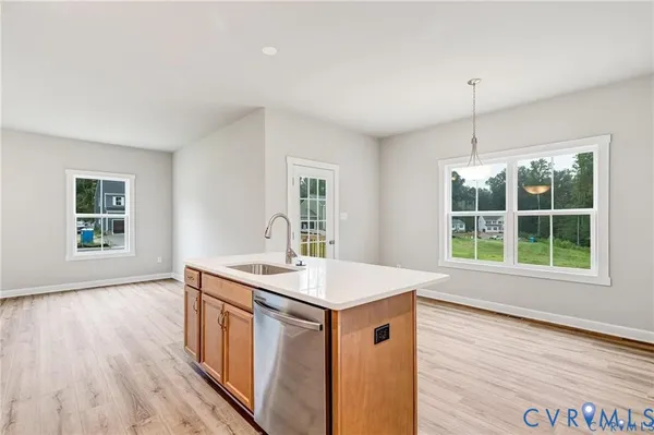 a view of a room with wooden floor and windows