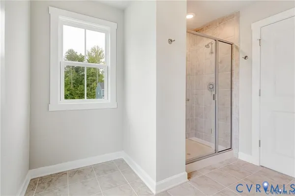 a bathroom with a shower and a window