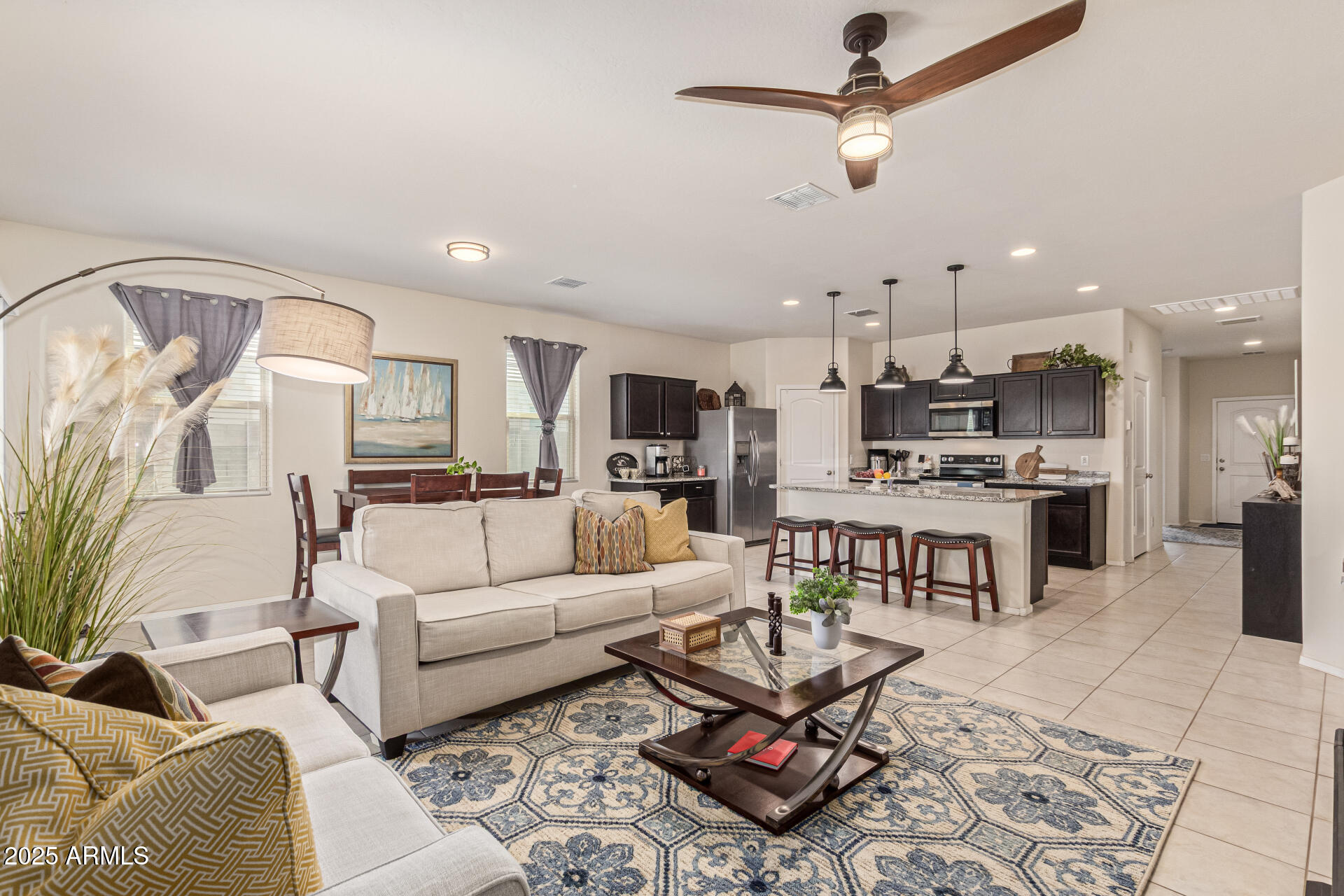 41844 West Rosa Drive Maricopa, AZ 85138 - Photo 17 of 47 a living room with furniture and kitchen view