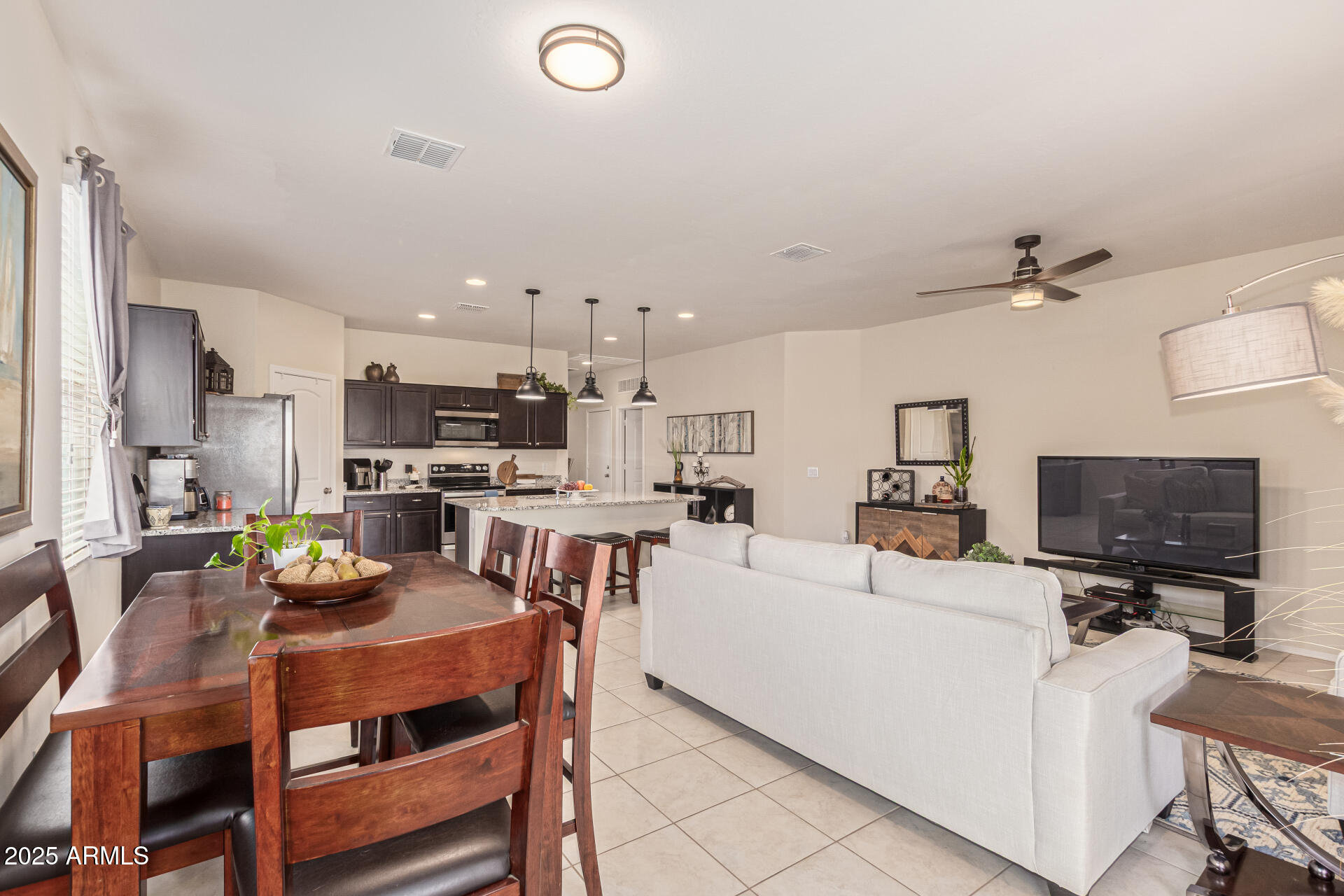 41844 West Rosa Drive Maricopa, AZ 85138 - Photo 46 of 47 a living room with stainless steel appliances furniture a rug and a view of kitchen