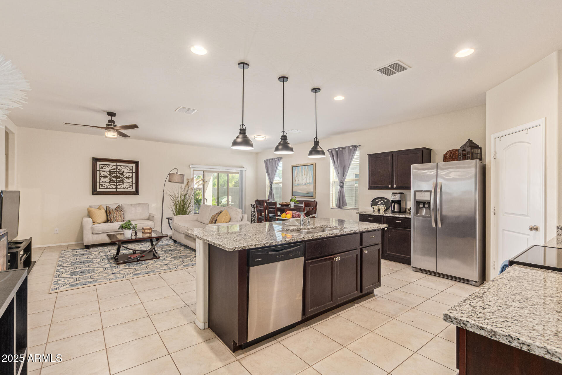 41844 West Rosa Drive Maricopa, AZ 85138 - Photo 47 of 47 a kitchen with stainless steel appliances granite countertop a sink a stove and a refrigerator