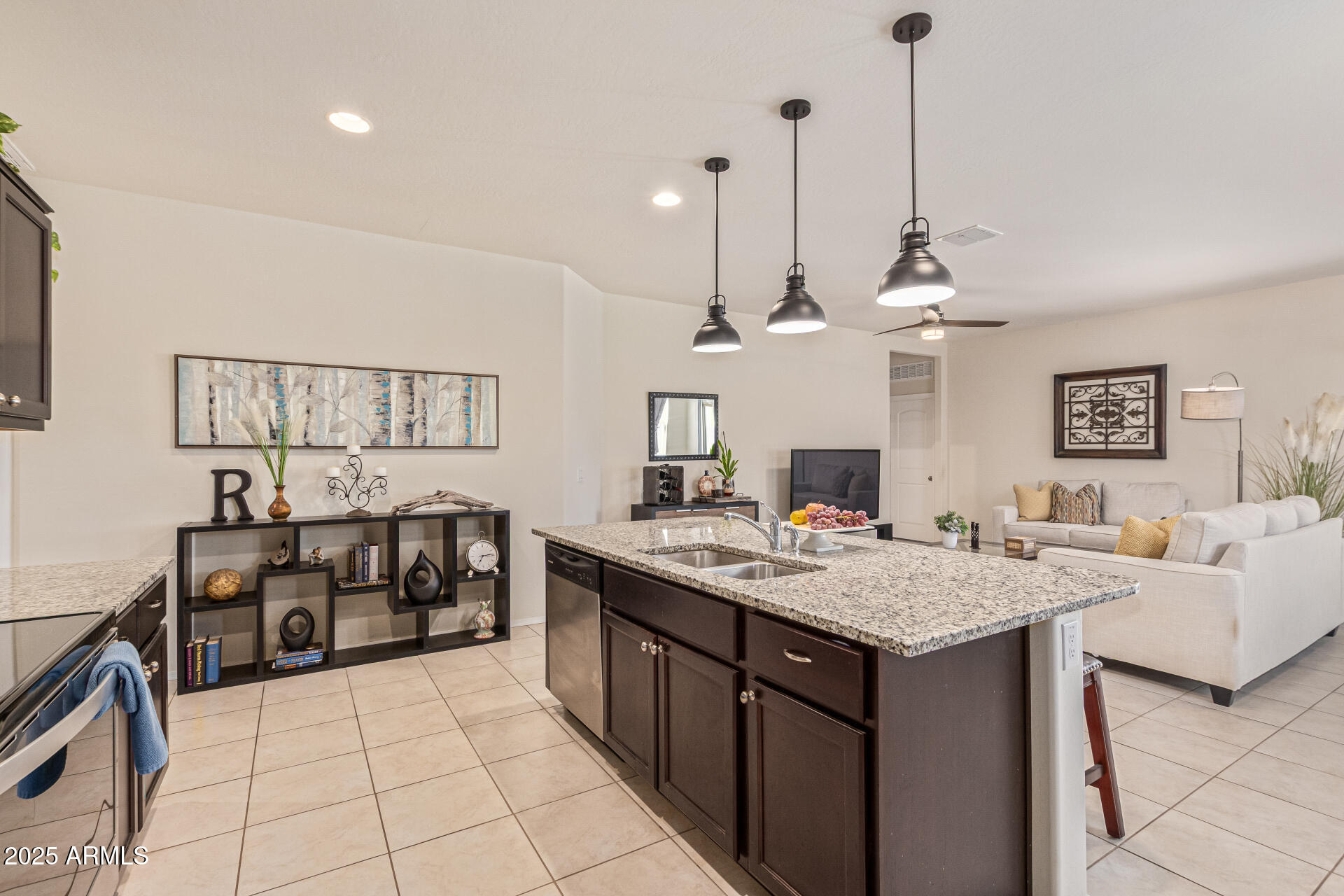 41844 West Rosa Drive Maricopa, AZ 85138 - Photo 22 of 47 a open kitchen with stainless steel appliances granite countertop a sink a stove and chairs