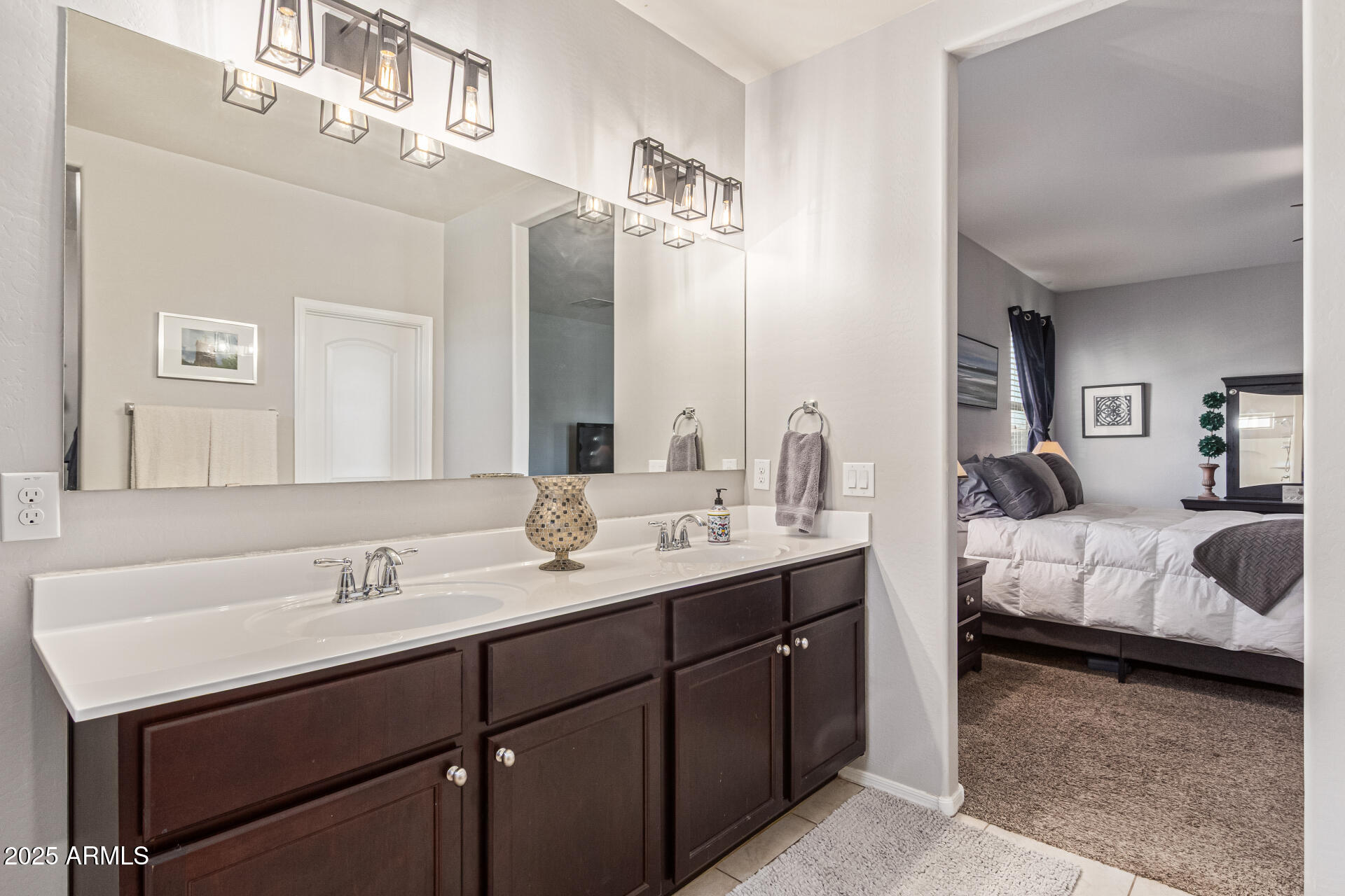 41844 West Rosa Drive Maricopa, AZ 85138 - Photo 27 of 47 a en suite bathroom with a double vanity sink and a mirror