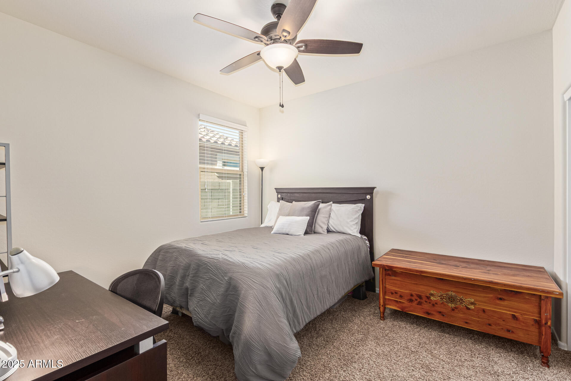 41844 West Rosa Drive Maricopa, AZ 85138 - Photo 36 of 47 a bedroom with a bed and a chandelier fan