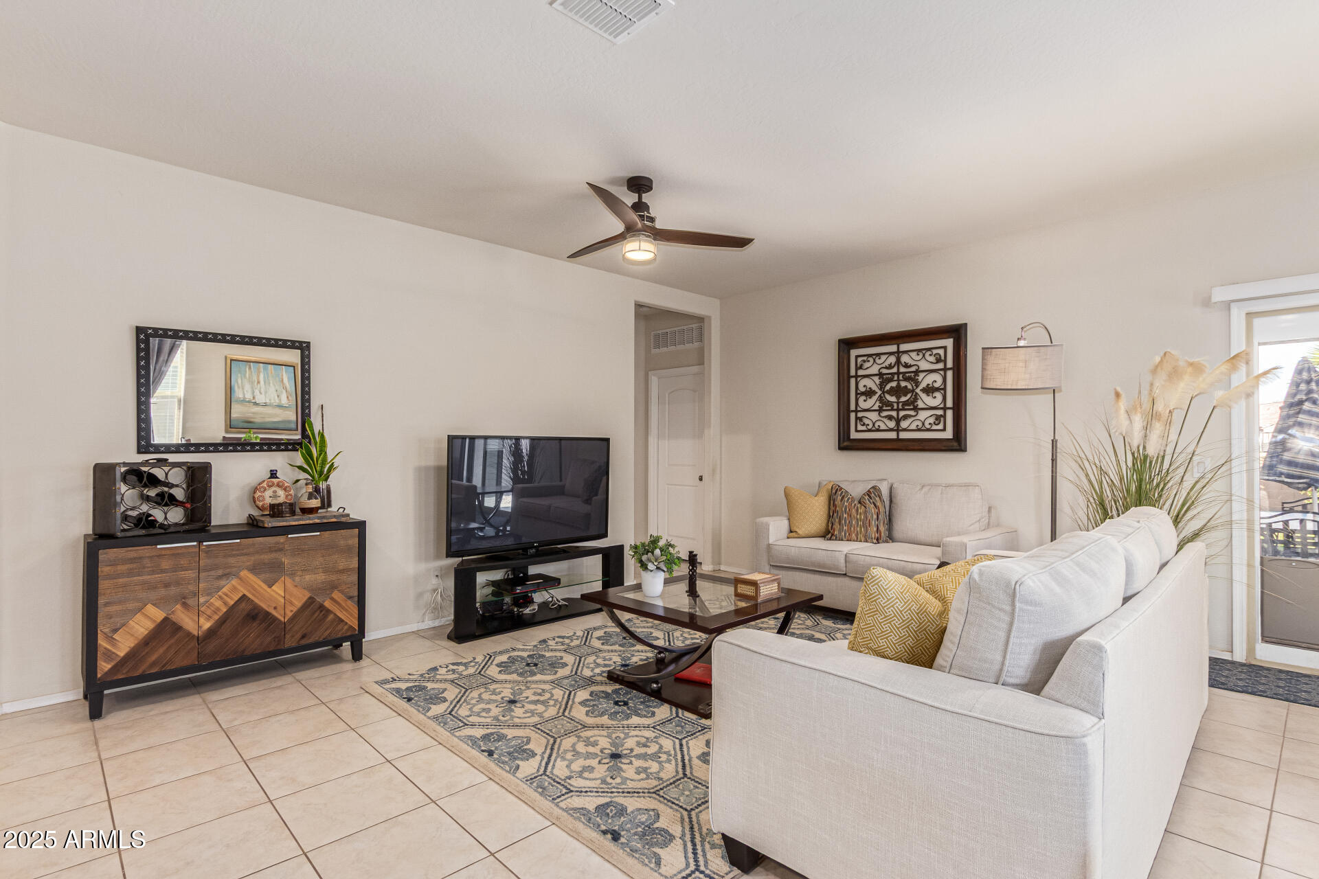 41844 West Rosa Drive Maricopa, AZ 85138 - Photo 4 of 47 a living room with furniture and a flat screen tv