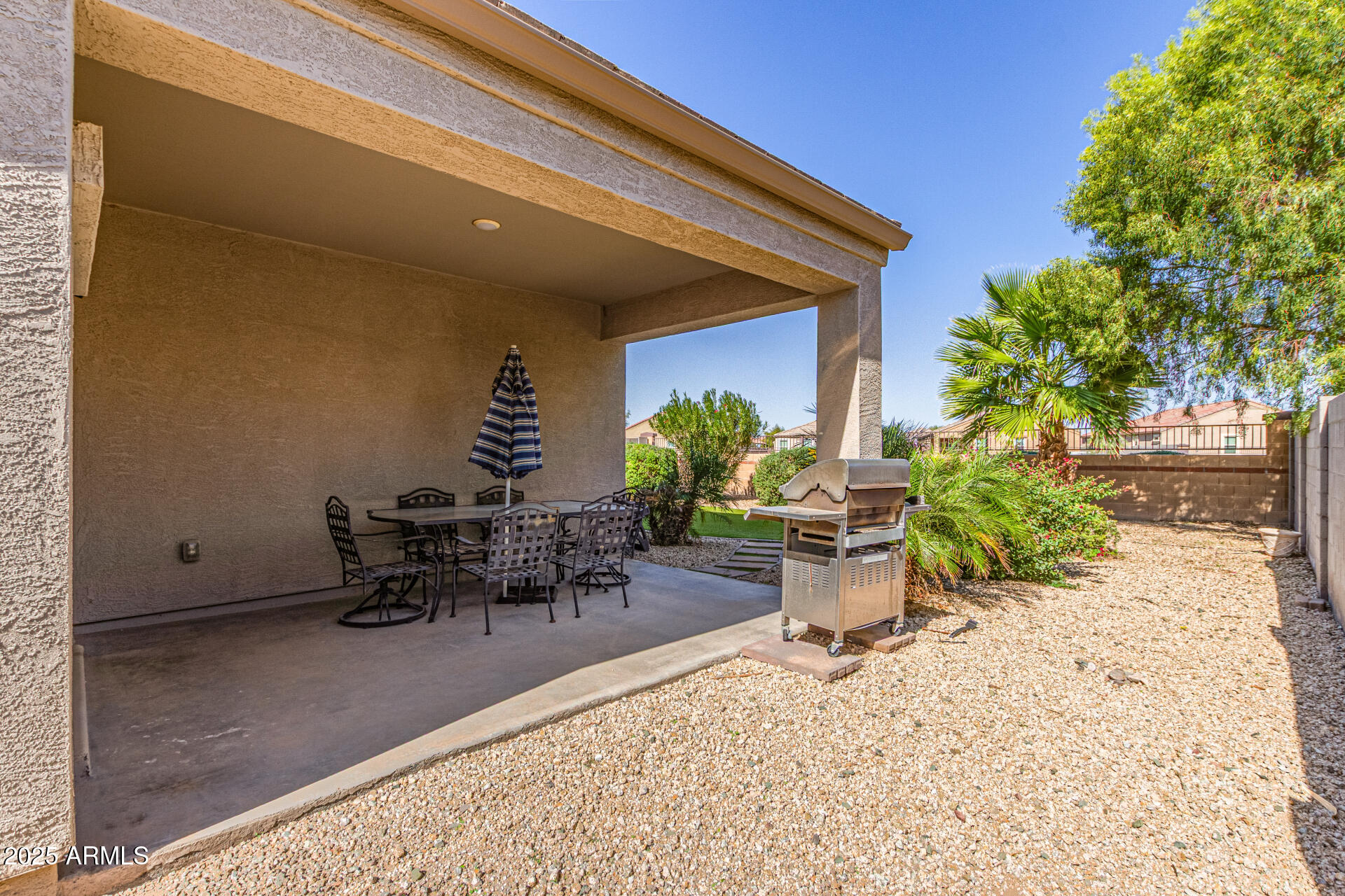 41844 West Rosa Drive Maricopa, AZ 85138 - Photo 45 of 47 a view of a patio with table and chairs and potted plants