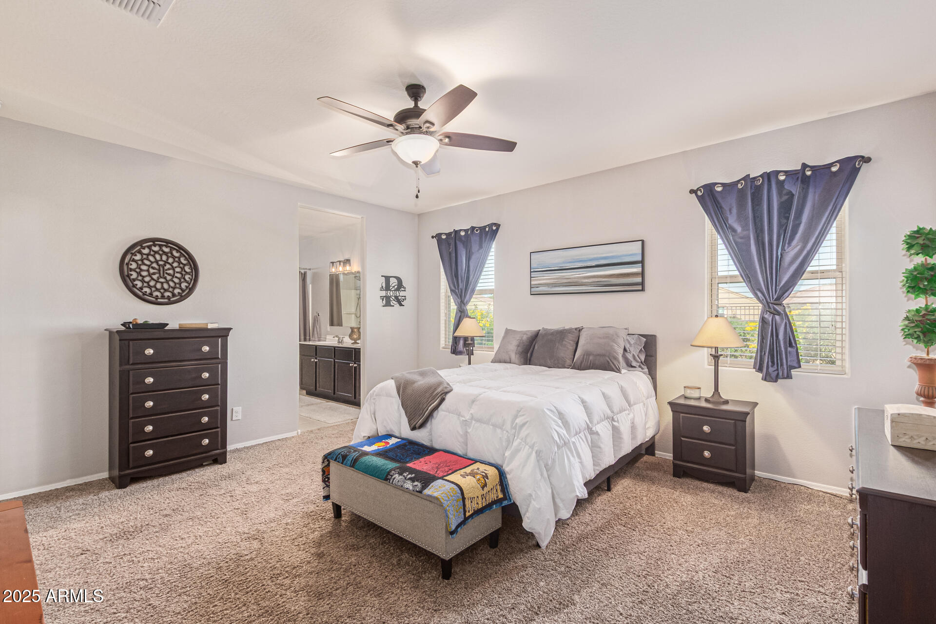 41844 West Rosa Drive Maricopa, AZ 85138 - Photo 5 of 47 a spacious bedroom with a bed a window and dresser