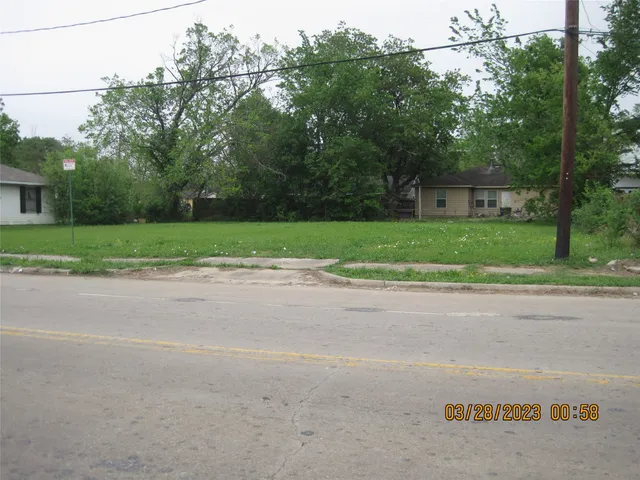 a view of a house with a big yard and large trees