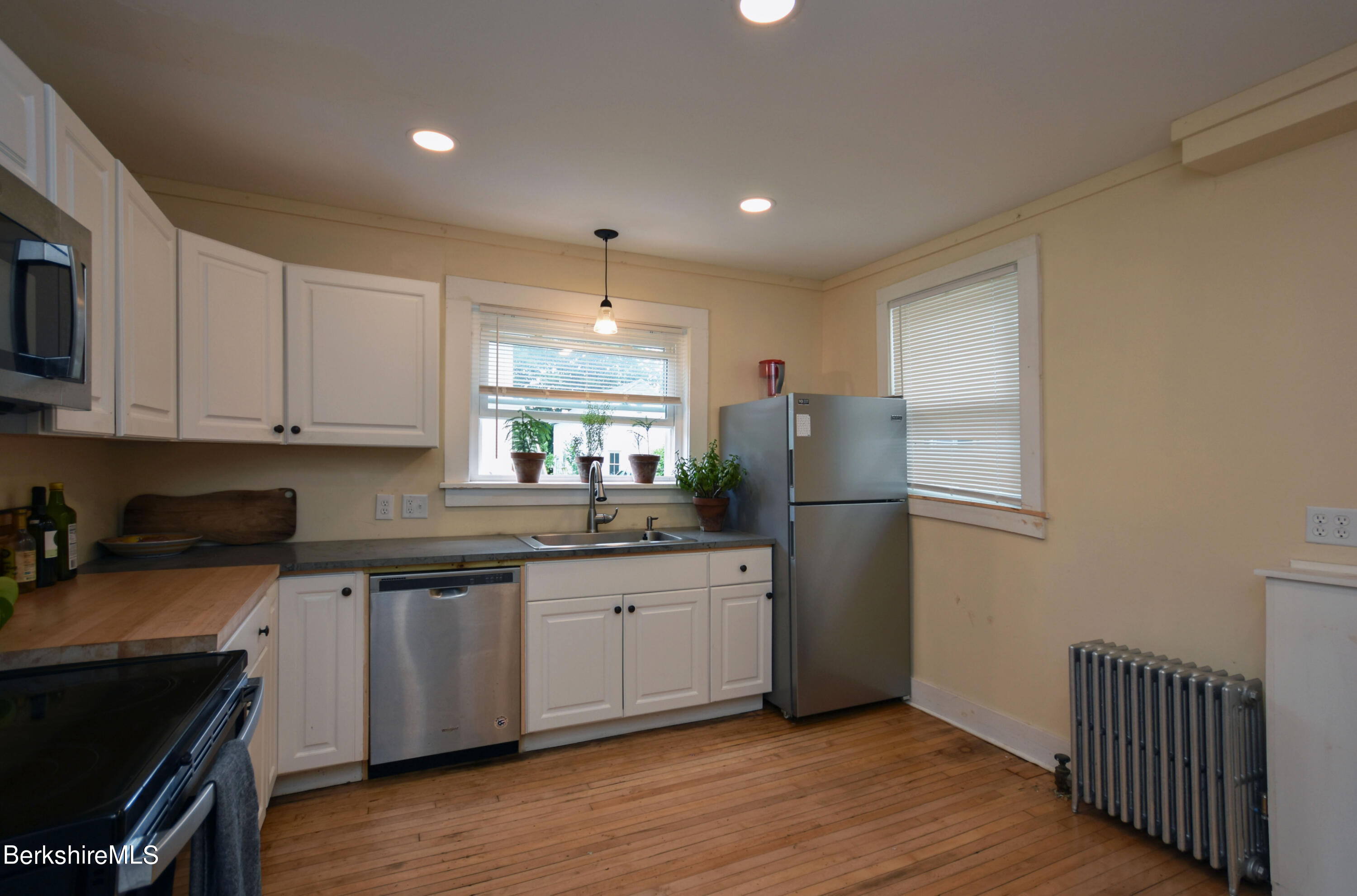 26 Elizabeth Street Pittsfield, MA 01201 - Photo 11 of 43 a kitchen with stainless steel appliances granite countertop a stove a sink and a refrigerator