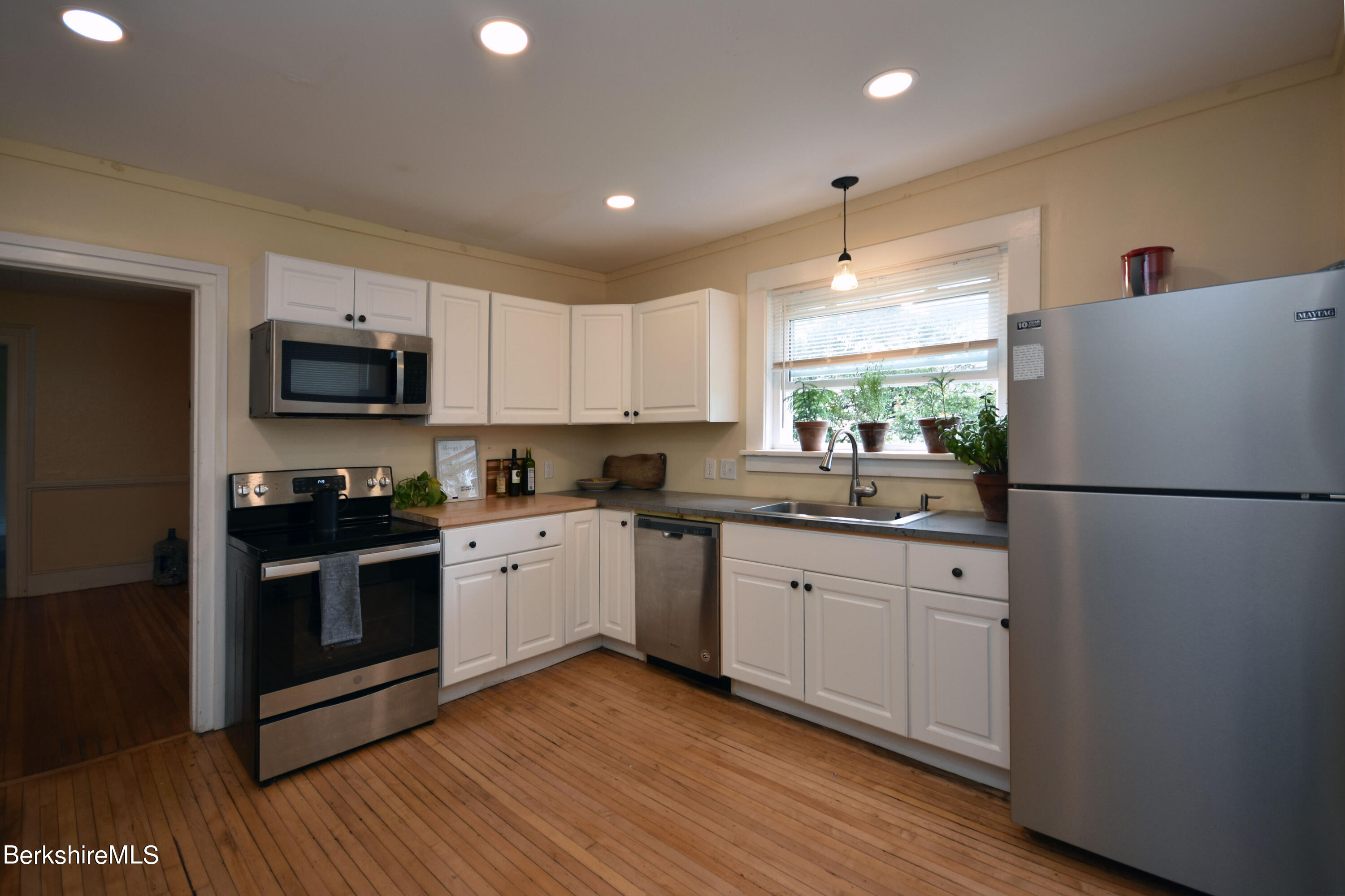 26 Elizabeth Street Pittsfield, MA 01201 - Photo 12 of 43 a kitchen with granite countertop a refrigerator stove top oven and sink