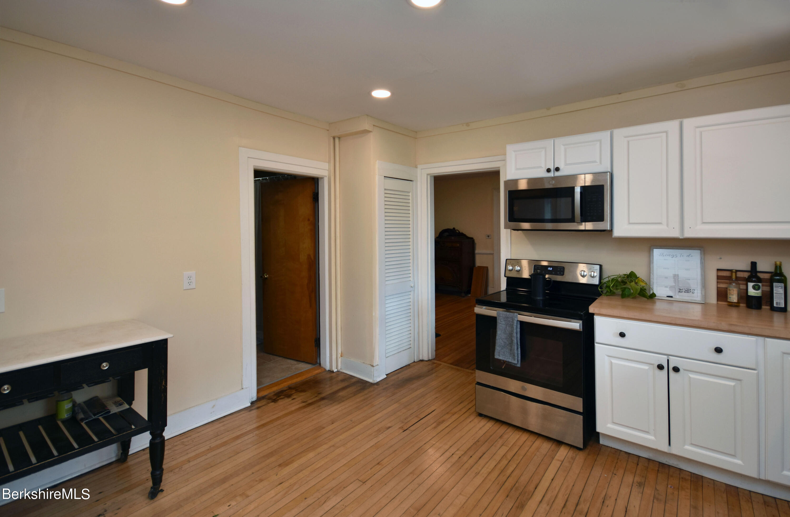 26 Elizabeth Street Pittsfield, MA 01201 - Photo 13 of 43 a kitchen with stainless steel appliances a stove microwave and sink