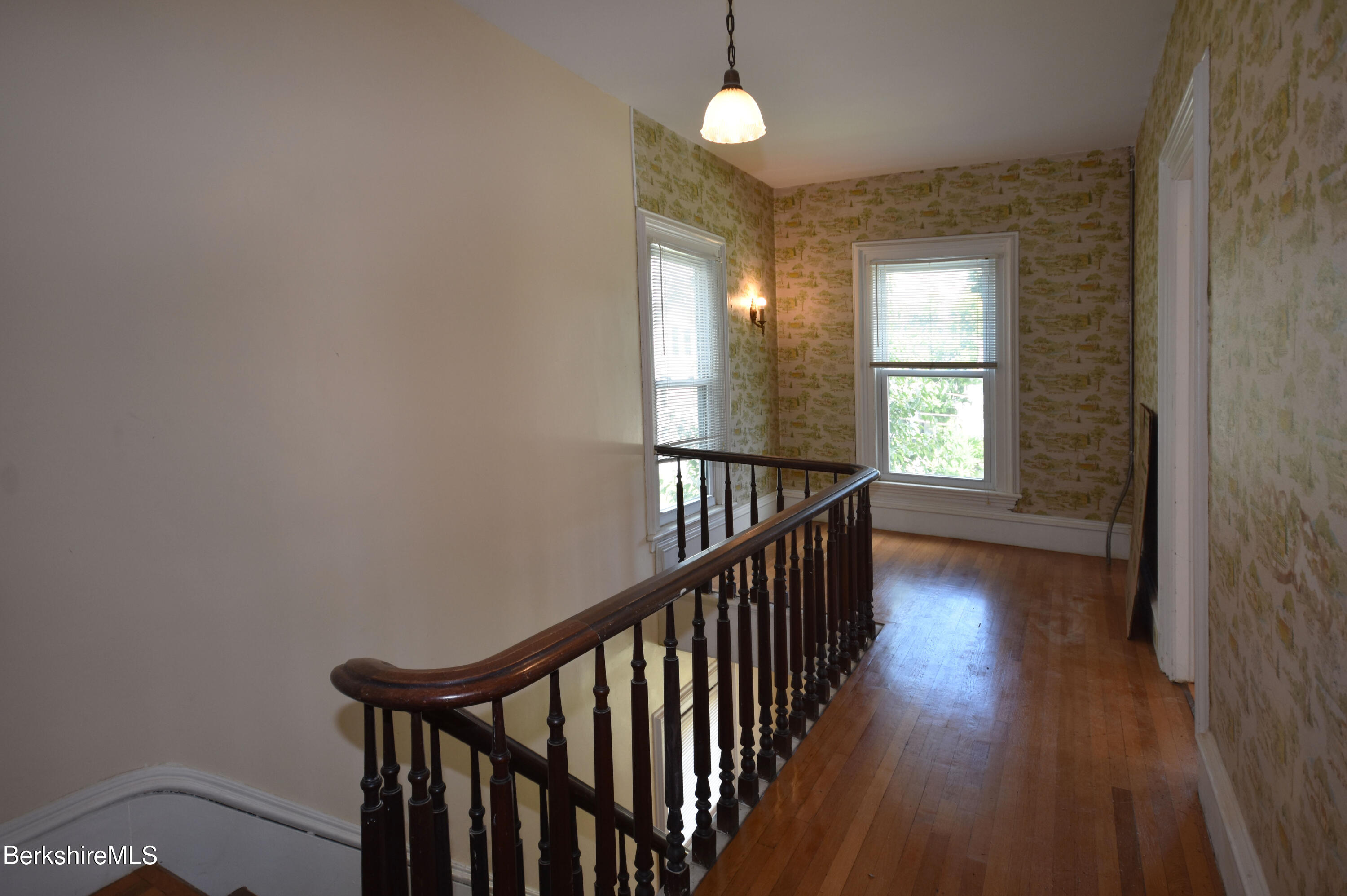 26 Elizabeth Street Pittsfield, MA 01201 - Photo 19 of 43 a view of a hallway with wooden floor and windows