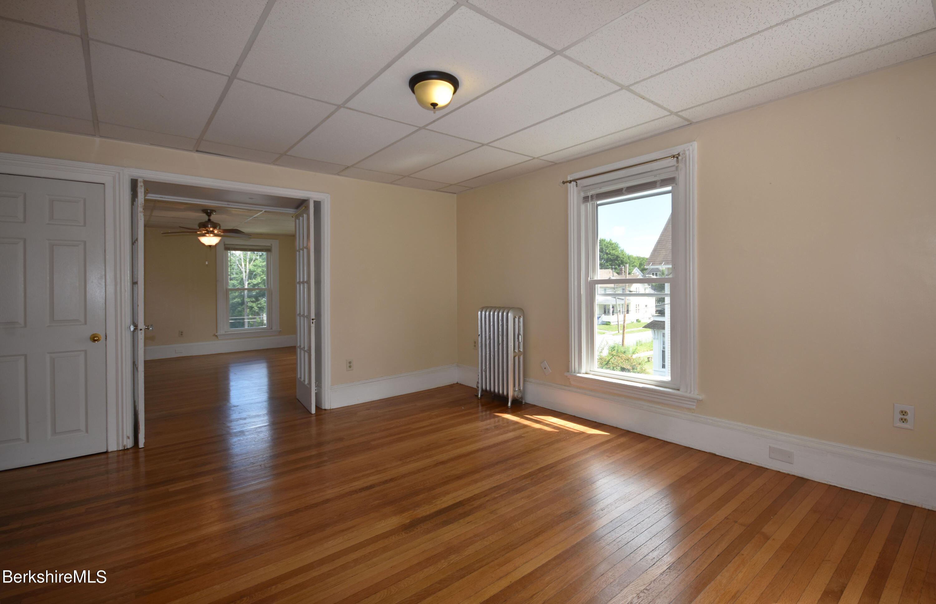 26 Elizabeth Street Pittsfield, MA 01201 - Photo 21 of 43 an empty room with wooden floor and windows