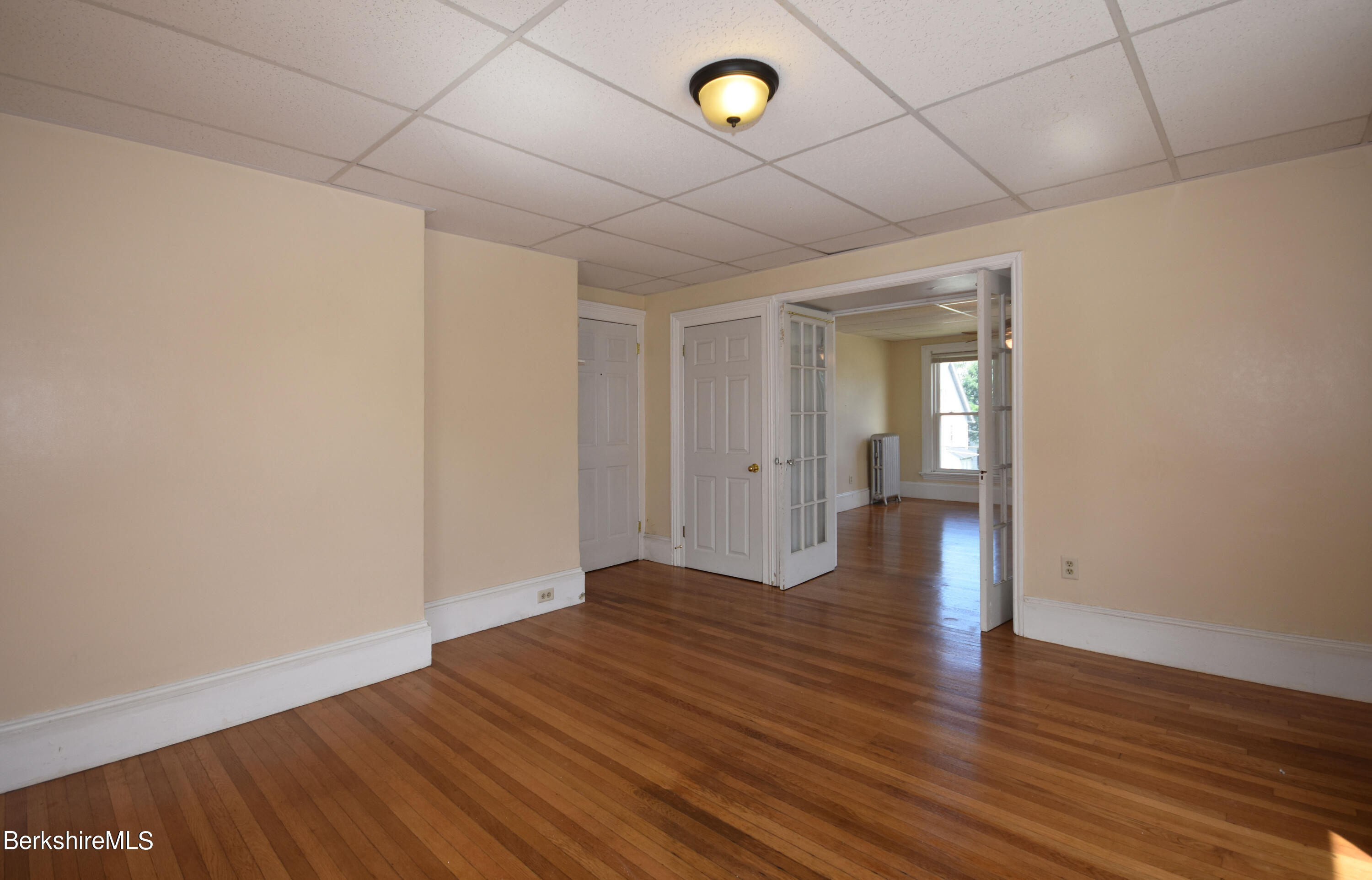 26 Elizabeth Street Pittsfield, MA 01201 - Photo 22 of 43 a view of an empty room with wooden floor
