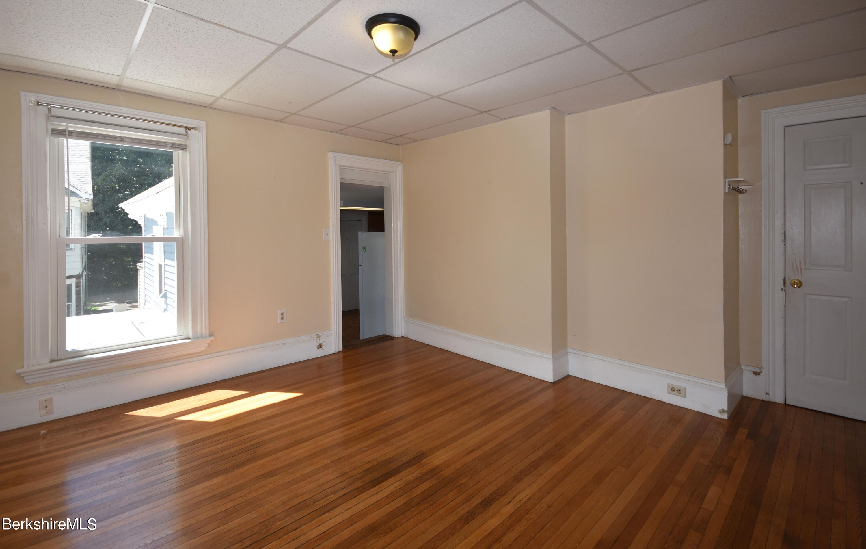 26 Elizabeth Street Pittsfield, MA 01201 - Photo 23 of 43 an empty room with wooden floor and windows
