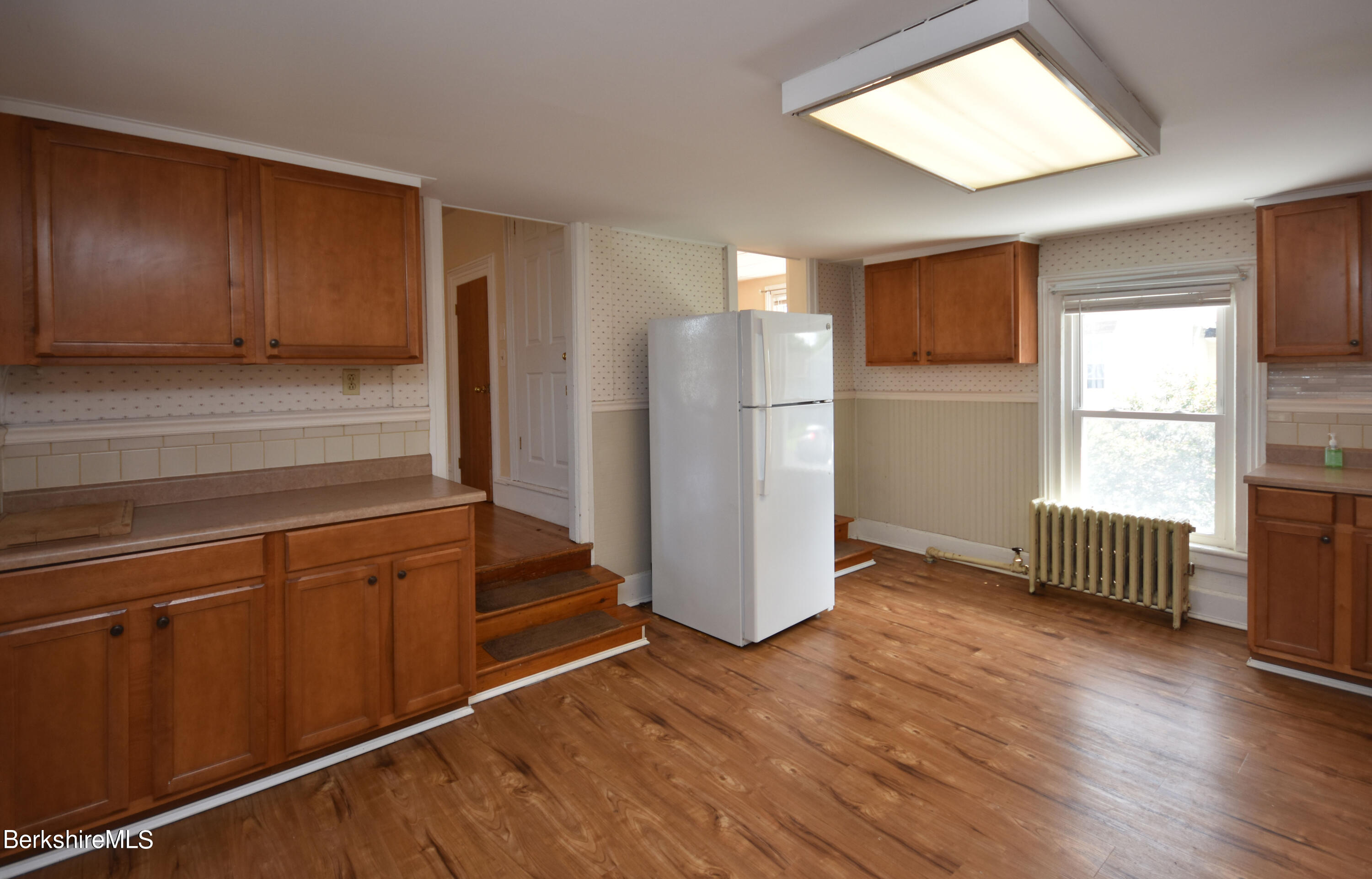 26 Elizabeth Street Pittsfield, MA 01201 - Photo 24 of 43 a view of a kitchen with wooden floor and electronic appliances