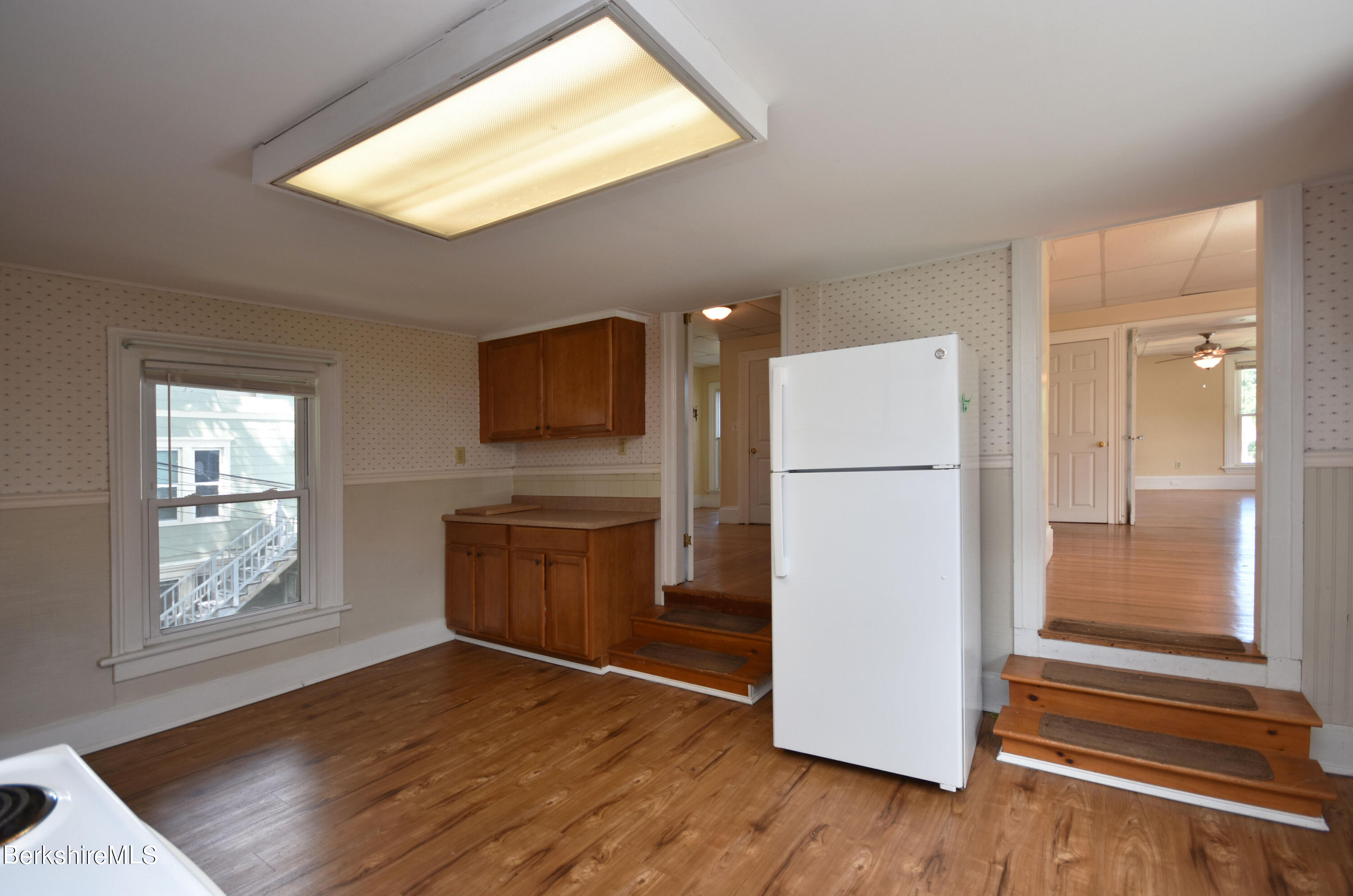 26 Elizabeth Street Pittsfield, MA 01201 - Photo 26 of 43 a kitchen with a refrigerator and a stove top oven